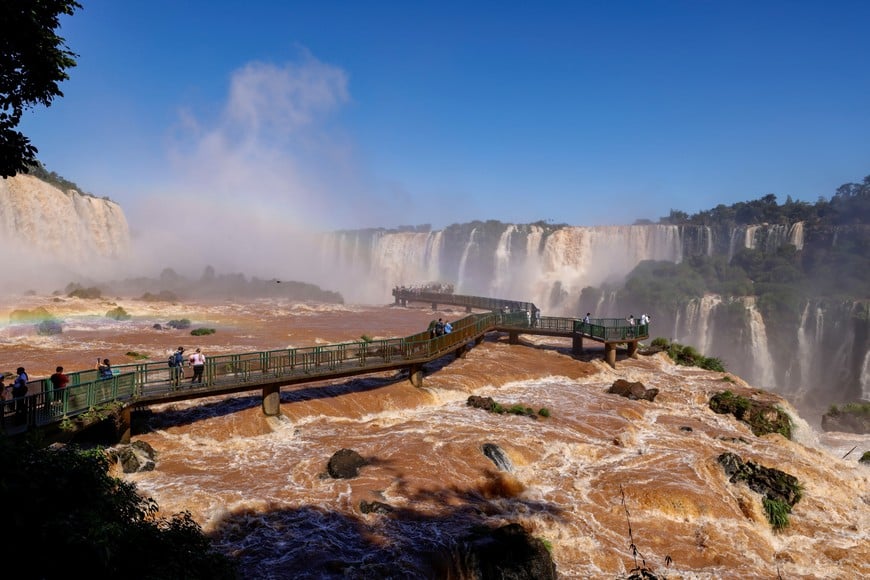 People tour Iguazu Falls, which are currently at full water capacity due to the rains in southern Brazil, at Iguazu Falls, Brazil, May 7, 2024. REUTERS/Kiko Sierich