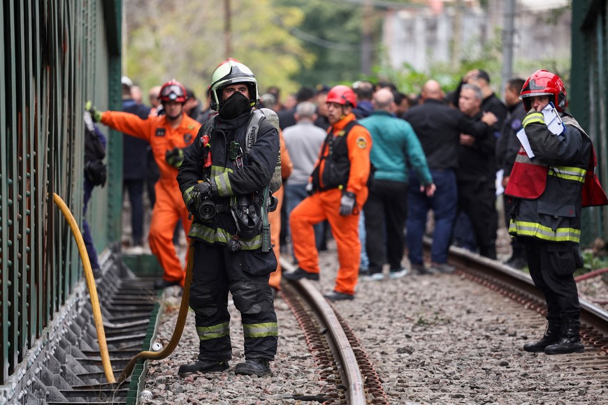 A fire fighters works on the site of a train collision in Buenos Aires, Argentina, May 10, 2024. REUTERS/Agustin Marcarian