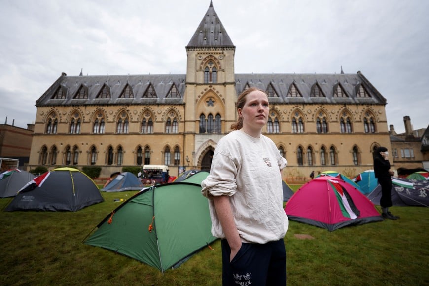 Student Rosy Wilson, 19, looks on near tents at Oxford University, outside Oxford University Museum of Natural History, as students occupy parts of British university campuses to protest in support of Palestinians in Gaza, amidst the ongoing conflict between Israel and the Palestinian Islamist group Hamas, in Oxford, Britain, May 6, 2024. REUTERS/Hollie Adams