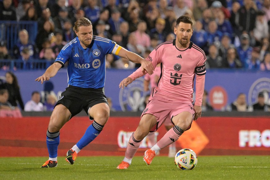 May 11, 2024; Montreal, Quebec, CAN; Inter Miami CF forward Lionel Messi (10) and CF Montreal midfielder Samuel Piette (6) battle for the ball in the second half at Stade Saputo. Mandatory Credit: Eric Bolte-USA TODAY Sports