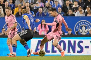 May 11, 2024; Montreal, Quebec, CAN; Inter Miami CF forward Lionel Messi (10) battles for the ball against CF Montreal midfielder Samuel Piette (6) in the second half at Stade Saputo. Mandatory Credit: Eric Bolte-USA TODAY Sports