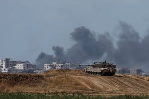 An Israeli tank holds a position as smoke rises in Gaza, near the Israel-Gaza border, amid the ongoing conflict between Israel and the Palestinian Islamist group Hamas, in Israel, May 13, 2024. REUTERS/Amir Cohen