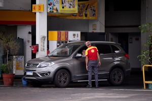 (240103) -- BUENOS AIRES, 3 enero, 2024 (Xinhua) -- Un empleado atiende a una clienta en una estación de servicio, en la ciudad de Buenos Aires, capital de Argentina, el 3 de enero de 2024. Las compañías petroleras en Argentina aumentaron el miércoles los precios de los combustibles alrededor de un 27 por ciento, alza que se agrega a los incrementos que sumaron un 67 por ciento en diciembre pasado. (Xinhua/Martín Zabala) (mz) (jg) (da) (vf)