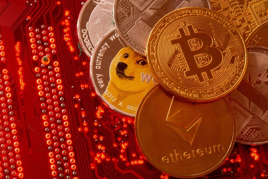 FILE PHOTO: Representations of cryptocurrencies Bitcoin, Ethereum, DogeCoin, Ripple, Litecoin are placed on PC motherboard in this illustration taken, June 29, 2021. REUTERS/Dado Ruvic/File Photo
