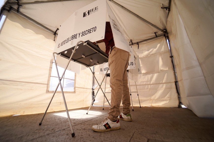 A person votes at a polling station for Mexico's general election, in Mexicali, Mexico June 2, 2024. The writing reads: The vote is free and secret." REUTERS/Victor Medina