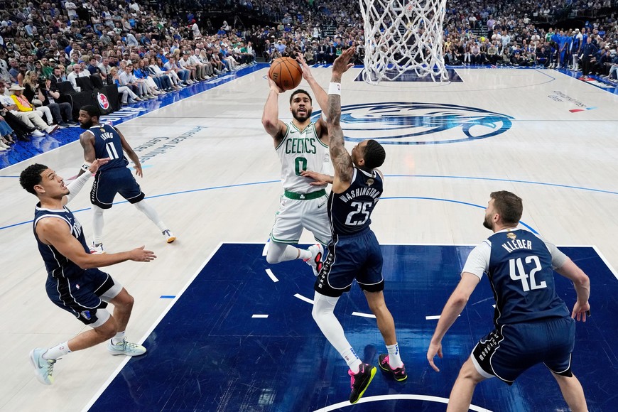 Jun 14, 2024; Dallas, Texas, USA; Boston Celtics forward Jayson Tatum (0) shoots the ball against Dallas Mavericks forward P.J. Washington (25) during game four of the 2024 NBA Finals at American Airlines Center. Mandatory Credit: Stacy Revere/Pool Photo-USA TODAY Sports