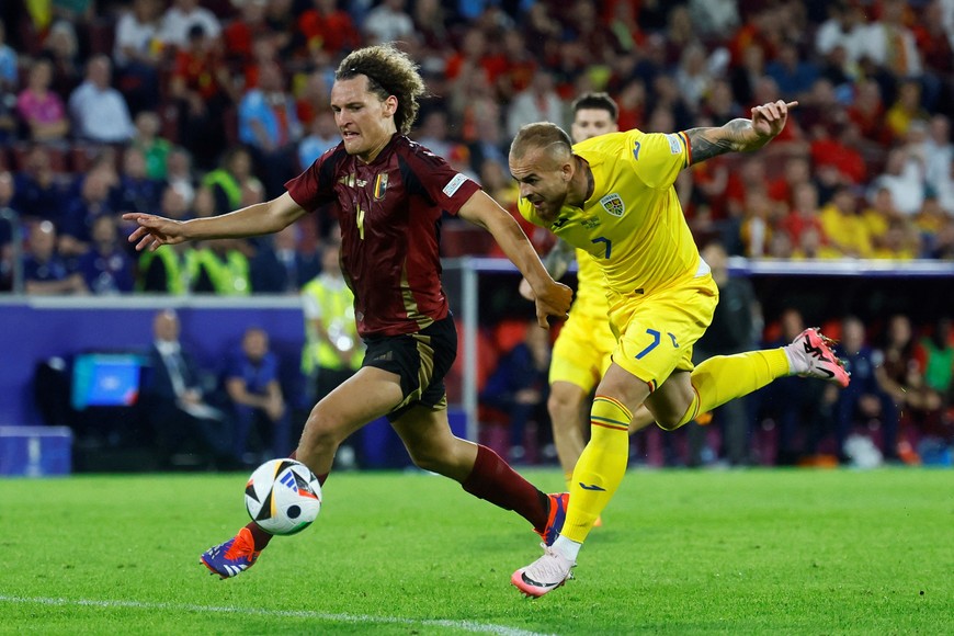 Soccer Football - Euro 2024 - Group E - Belgium v Romania - Cologne Stadium, Cologne, Germany - June 22, 2024
Belgium's Wout Faes in action with Romania's Denis Alibec REUTERS/Wolfgang Rattay
