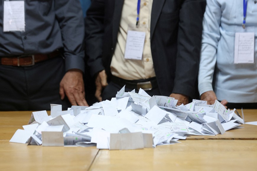 Electoral staff members stand next to ballots at a polling station after voting ended in Iran's run-off presidential election between Masoud Pezeshkian and Saeed Jalili, in Tehran, Iran July 6, 2024. Majid Asgaripour/WANA (West Asia News Agency) via REUTERS ATTENTION EDITORS - THIS PICTURE WAS PROVIDED BY A THIRD PARTY