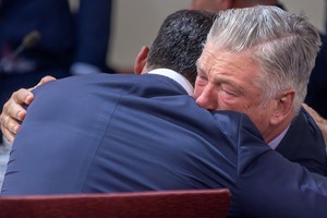 Actor Alec Baldwin hugs his defense attorney Alex Spiro after District Court Judge Mary Marlowe Sommer dismissed the case against Baldwin on Friday, July 12, 2024.    Luis Sanchez Saturno/The New Mexican/Pool via REUTERS