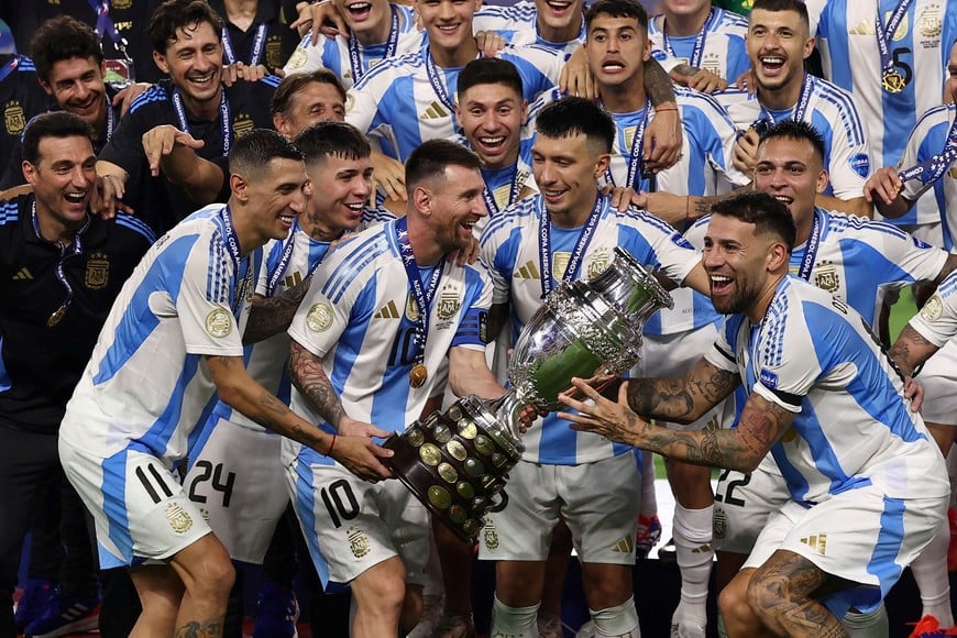 Soccer Football - Copa America 2024 - Final - Argentina v Colombia - Hard Rock Stadium, Miami, Florida, United States - July 15, 2024
Argentina's Lionel Messi lifts the trophy as he celebrates with teammates after winning Copa America 2024
REUTERS/Agustin Marcarian