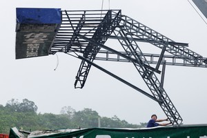 A man helps to remove a fallen sign after Typhoon Gaemi passed northern Taiwan in Yilan, Taiwan July 25, 2024. REUTERS/Carlos Garcia Rawlins