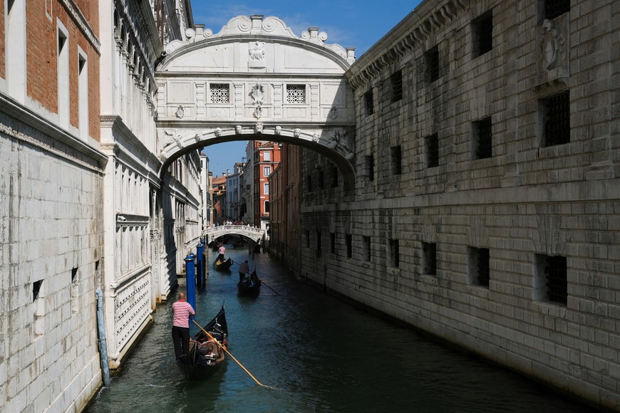 People ride on gondolas as the municipality prepares to charge tourists up to 10 Euro for entry into the lagoon city, in order to cut down the number of visitors, in Venice, Italy, September 5, 2021.  Picture taken September 5, 2021. REUTERS/Manuel Silvestri