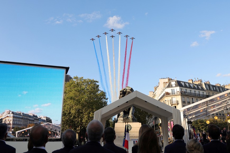French Air Patrol flies to display the colors of the French flag during a ceremony to commemorate the 80th anniversary of the Liberation of Paris next to the Denfert Rocherau Square in Paris, France, August 25, 2024. Teresa Suarez/Pool via REUTERS
