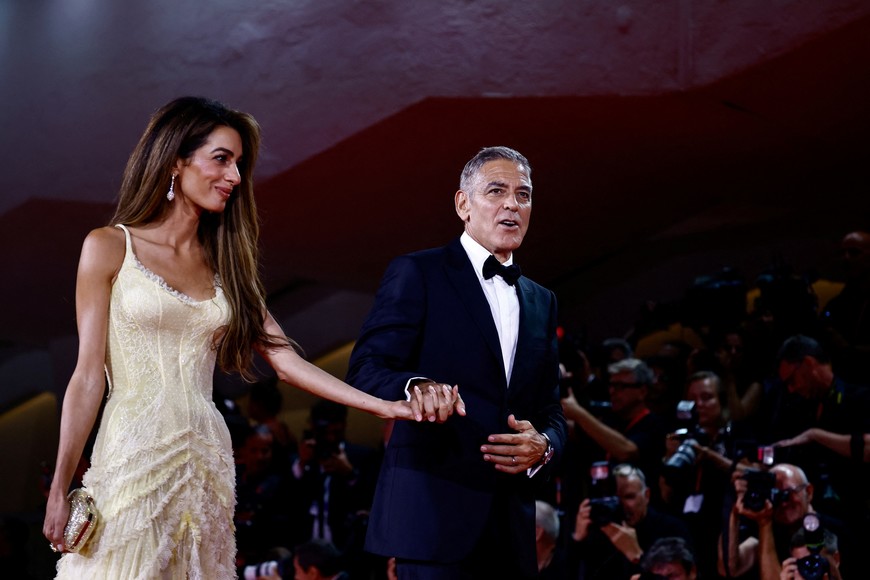 George Clooney and Amal Clooney walk on the red carpet during arrivals for the movie "Wolfs" presented out of competition, during the 81st Venice Film Festival, in Venice, Italy, September 1, 2024. REUTERS/Yara Nardi
