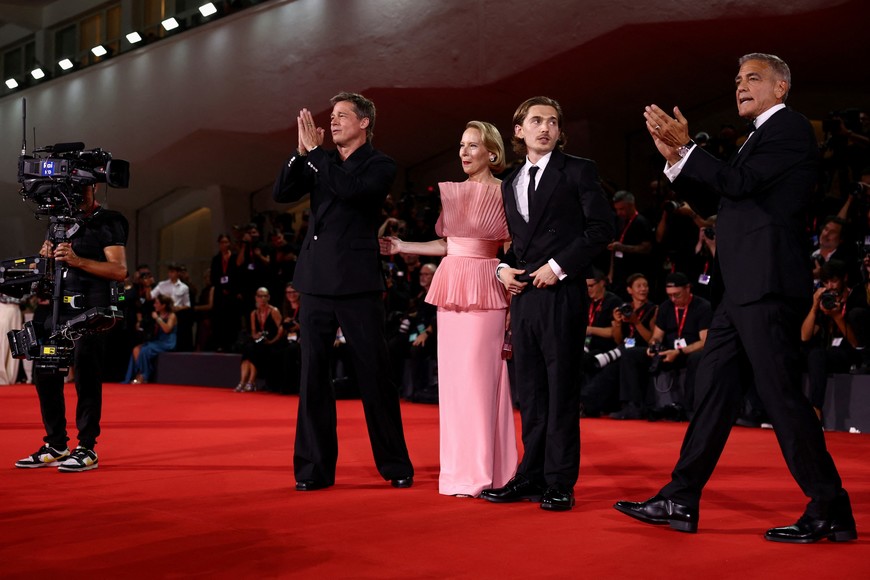 Austin Abrams, George Clooney, Brad Pitt and Amy Ryan pose on the red carpet during arrivals for the movie "Wolfs" presented out of competition, during the 81st Venice Film Festival, in Venice, Italy, September 1, 2024. REUTERS/Yara Nardi