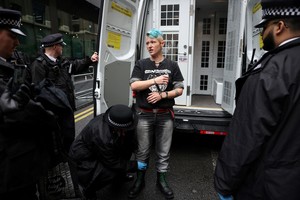 Tez Burns of Just Stop Oil, is handcuffed by police outside Southwark Crown Court, on the day that Anna Holland and Phoebe Plummer are sentenced after they were convicted of criminal damage for throwing tins of Heinz tomato soup at Vincent van Gogh's "Sunflowers" painting in London's National Gallery in 2022, in London, Britain, September 27, 2024. REUTERS/Isabel Infantes