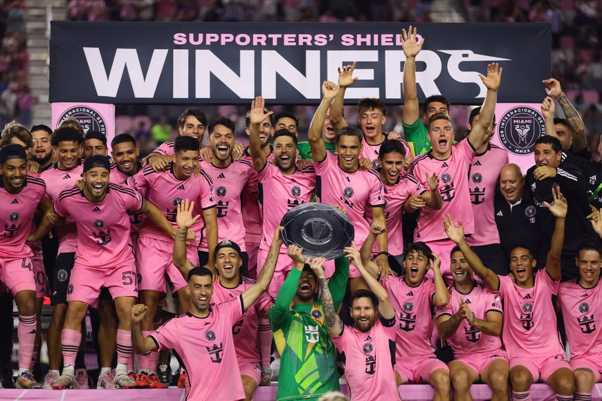 Oct 19, 2024; Fort Lauderdale, Florida, USA; Inter Miami CF goalkeeper Drake Callender (1) (middle) and defender Sergio Busquets (5) (left) and forward Lionel Messi (10) (right) raise the supporters shield post game against the New England Revolution at Chase Stadium. Mandatory Credit: Sam Navarro-Imagn Images