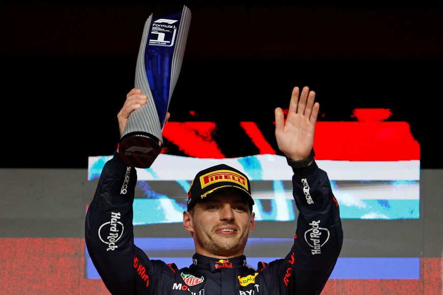 Formula One F1 - Qatar Grand Prix - Lusail International Circuit, Lusail, Qatar - December 1, 2024 
Red Bull's Max Verstappen celebrates with a trophy on the podium after winning the Qatar Grand Prix REUTERS/Hamad I Mohammed