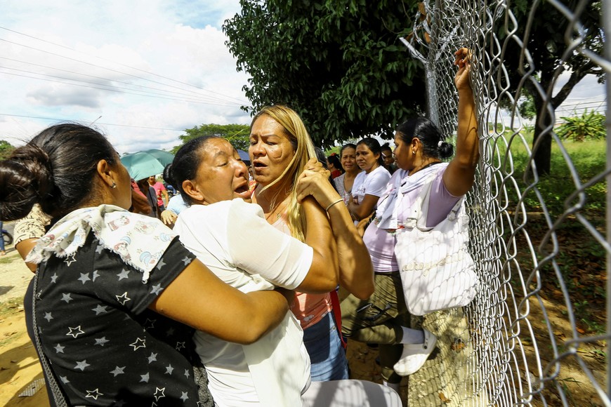 A woman reacts outside a prison next to other family members as they wait for news about their loved ones who were detained during protests over a contested July presidential election, in Tocuyito, Venezuela December 16, 2024. REUTERS/Juan Carlos Hernandez