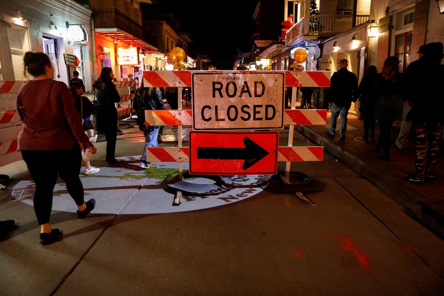 People walk past a 'Road Closed' sign at Bourbon Street, two days after people were killed by a U.S. Army veteran who drove a truck into a crowd celebrating New Year's Day, in New Orleans, Louisiana, U.S., January 3, 2025. REUTERS/Octavio Jones