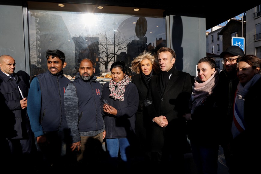 France's President Emmanuel Macron and his wife Brigitte pose with staff of the Hypercacher supermarket as they attend commemorations marking 10 years since an Islamist attack on the Charlie Hebdo satirical newspaper and the Hypercacher jewish supermarket in Paris, on January 7, 2025. LUDOVIC MARIN/Pool via REUTERS