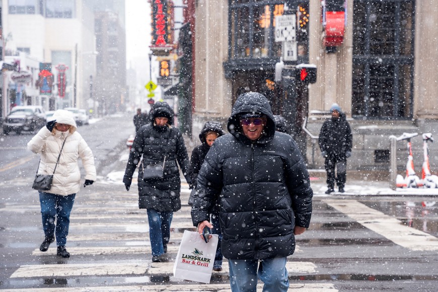 People walk on Broadway in downtown Nashville as winter storm Cora makes its way through the southern United States in Nashville, Tennessee, U.S. January 10, 2025.  REUTERS/Seth Herald