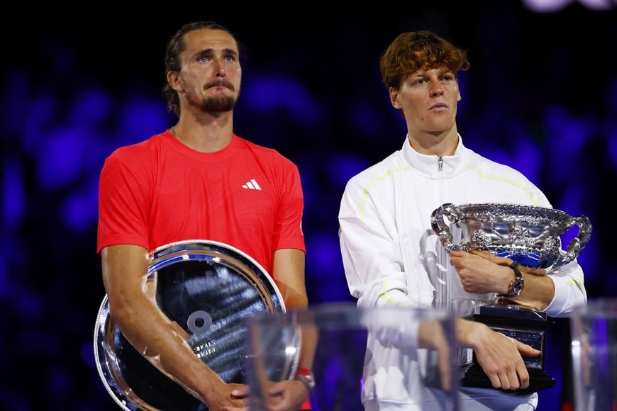 Tennis - Australian Open - Melbourne Park, Melbourne, Australia - January 26, 2025
Italy's Jannik Sinner poses with the trophy alongside Germany's Alexander Zverev after the final REUTERS/Edgar Su