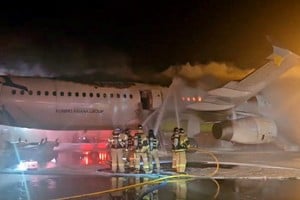 Firefighters try to put out the fire from an Air Busan plane at Gimhae International Airport in Busan, South Korea, January 28, 2025.   Yonhap/via REUTERS       ATTENTION EDITORS - THIS IMAGE HAS BEEN SUPPLIED BY A THIRD PARTY. NO RESALES. NO ARCHIVE. SOUTH KOREA OUT. NO COMMERCIAL OR EDITORIAL SALES IN SOUTH KOREA. BEST QUALITY AVAILABLE.