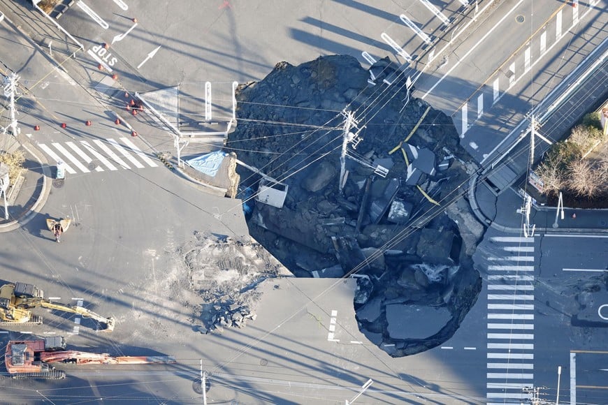 An aerial view shows a large sinkhole that formed when a sinkhole that swallowed a truck and a man believed to be its driver at an intersection in Yashio, formed on January 28, 2025, and another that formed during rescue operations, merged, near Tokyo, Japan January 30, 2025, in this photo taken by Kyodo.  Kyodo/via REUTERS ATTENTION EDITORS - THIS IMAGE HAS BEEN SUPPLIED BY A THIRD PARTY. MANDATORY CREDIT. JAPAN OUT. NO COMMERCIAL OR EDITORIAL SALES IN JAPAN.