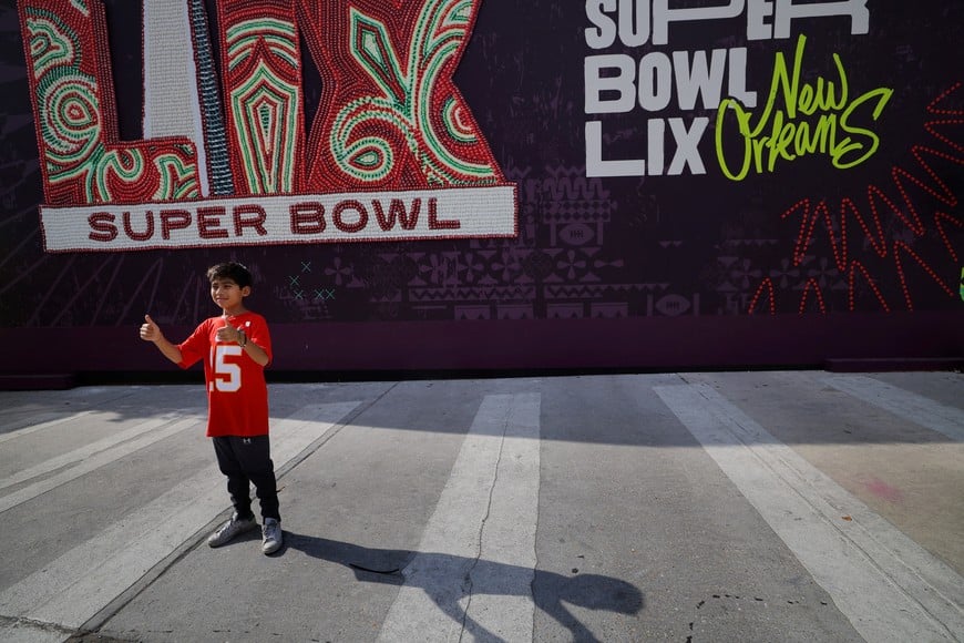 Eleven-year-old Abraham Israel, wearing the jersey of Kansas City Chiefs quarterback Patrick Mahomes, poses for his father outside the Superdome, site of the NFL’s Super Bowl LIX between the Chiefs and the Philadelphia Eagles, in New Orleans, Louisiana, U.S., February 7, 2025.   REUTERS/Brian Snyder