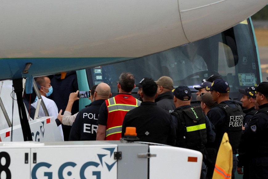 Law enforcement officers keep watch as migrants arrive in Costa Rica on a deportation flight from the U.S. before being sent to their home countries, at Juan Santamaria International Airport, in Alajuela, Costa Rica February 20, 2025. REUTERS/Mayela Lopez