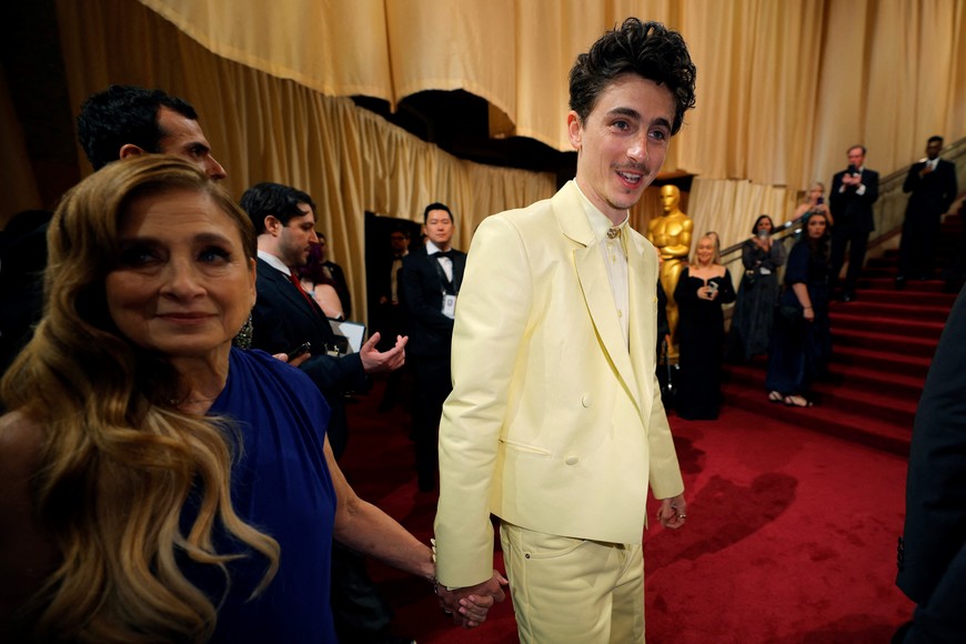 Timothee Chalamet and his mother Nicole Flender walk on the red carpet during the Oscars arrivals at the 97th Academy Awards in Hollywood, Los Angeles, California, U.S., March 2, 2025. REUTERS/Mike Blake