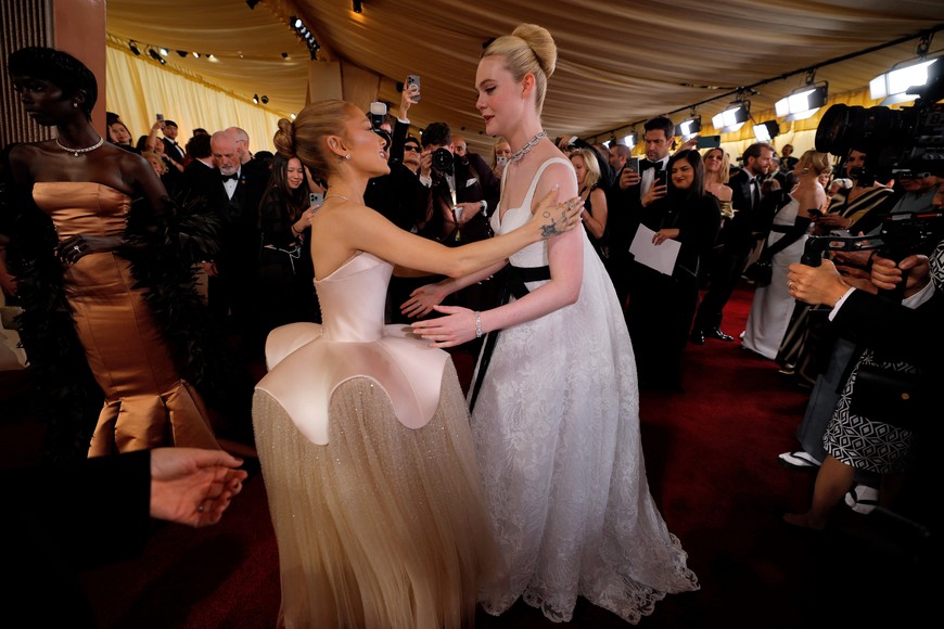 Elle Fanning and Ariana Grande greet one another on the red carpet during the Oscars arrivals at the 97th Academy Awards in Hollywood, Los Angeles, California, U.S., March 2, 2025. REUTERS/Mike Blake