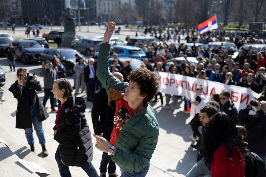 People throw eggs on parliament building during the opening session of this year's spring parliamentary convocation where it is expected to note a resignation of PM Milos Vucevic, in Belgrade, Serbia, March 4, 2025. REUTERS/Djordje Kojadinovic