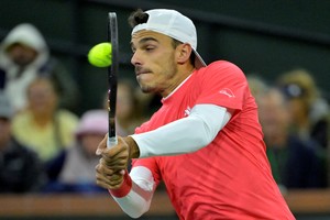 Mar 13, 2025; Indian Wells, CA, USA;  Francisco Cerundolo (ARG) hits a shot against Carlos Alcaraz (not pictured) in the quarterfinal of the BNP Paribas Open at the Indian Well Tennis Garden. Mandatory Credit: Jayne Kamin-Oncea-Imagn Images