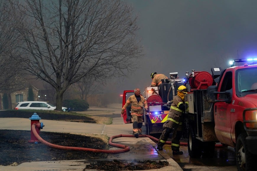 Firefighters work to extinguish fire during a wildfire outbreak in Stillwater, Oklahoma, U.S., March 14, 2025.  REUTERS/Nick Oxford