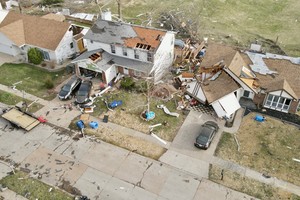 Debris lies around damaged houses the morning after a tornado touched down in Florissant, Missouri, U.S. March 15, 2025. REUTERS/Lawrence Bryant