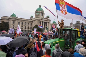 A man on a tractor waves a Serbian flag, as students and anti-government demonstrators take part in a protest, which has become a national movement for change following the deadly November 2024 Novi Sad railway station roof collapse, in front of the parliament building, in Belgrade, Serbia, March 15, 2025. REUTERS/Mitar Mitrovic