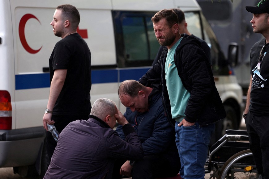 People react outside a hospital, following a fire in a night club resulting in casualties, in the town of Kocani, North Macedonia, March 16, 2025. REUTERS/Alexandros Avramidis