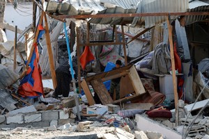 Palestinians inspect the site of an Israeli strike on a house, in Khan Younis in the southern Gaza Strip March 18, 2025. REUTERS/Hatem Khaled