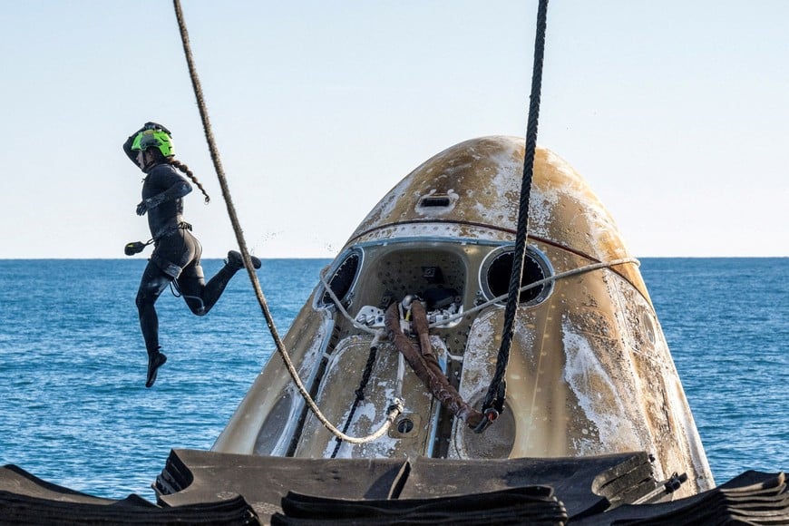 Support teams work around a SpaceX Dragon spacecraft shortly after it landed with NASA astronauts Nick Hague, Suni Williams, Butch Wilmore, and Roscosmos cosmonaut Aleksandr Gorbunov aboard in the waters off the coast of Tallahassee, Florida, Tuesday, March 18, 2025. NASA/Keegan Barber/ Handout via REUTERS  THIS PICTURE WAS PROCESSED BY REUTERS TO ENHANCE QUALITY. AN UNPROCESSED VERSION HAS BEEN PROVIDED SEPARATELY.     TPX IMAGES OF THE DAY