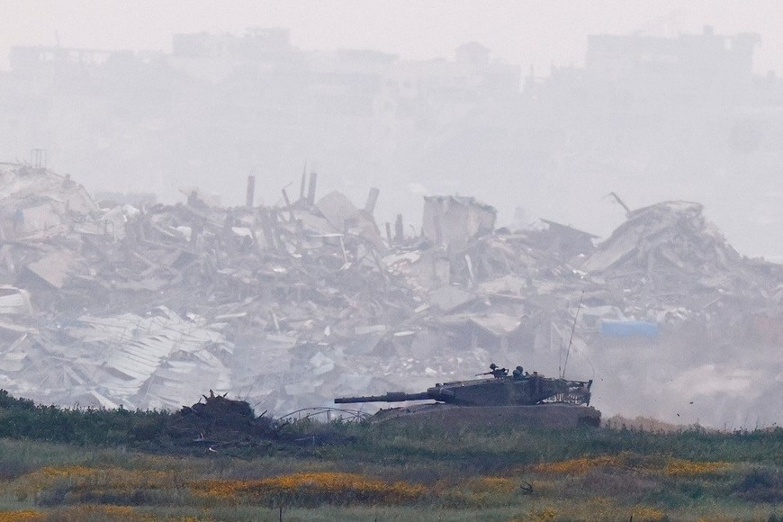 An Israeli tank manoeuvres inside Gaza, infront of destroyed buildings, as viewed from the Israel-Gaza border, March 20, 2025. REUTERS/Amir Cohen
