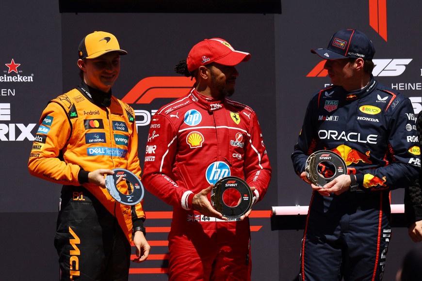 Formula One F1 - Chinese Grand Prix - Shanghai International Circuit, Shanghai, China - March 22, 2025
Ferrari's Lewis Hamilton poses with his trophy after winning the sprint race alongside second placed McLaren's Oscar Piastri and third placed Red Bull's Max Verstappen REUTERS/Edgar Su