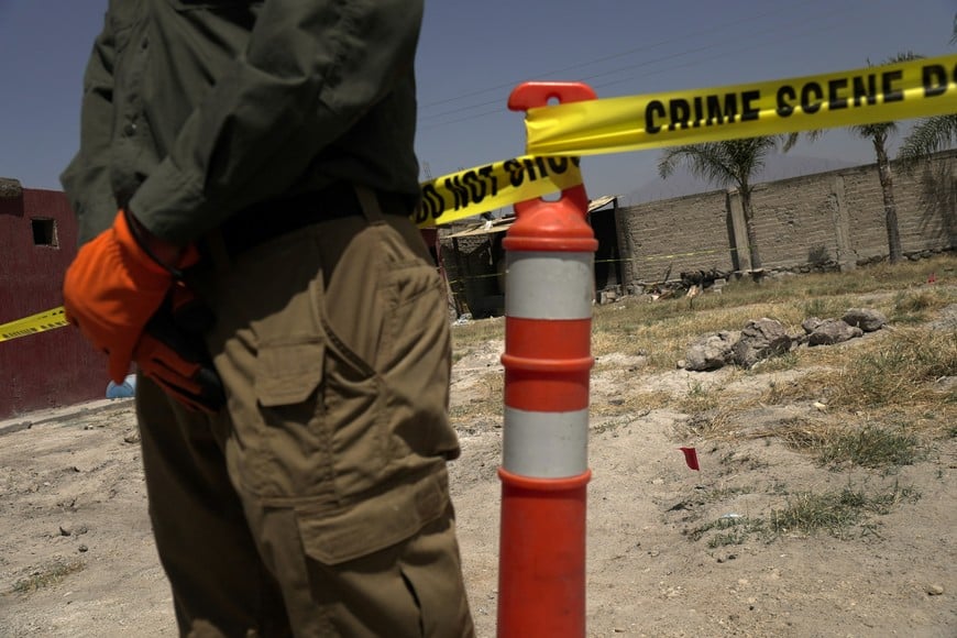 A security official stands next to a cordoned area during a media tour by Jalisco’s Attorney General Office at Izaguirre Ranch, which activists have called a cartel-run "extermination camp," in Teuchitlan, Jalisco state, Mexico March 20, 2025. REUTERS/Ivan Arias