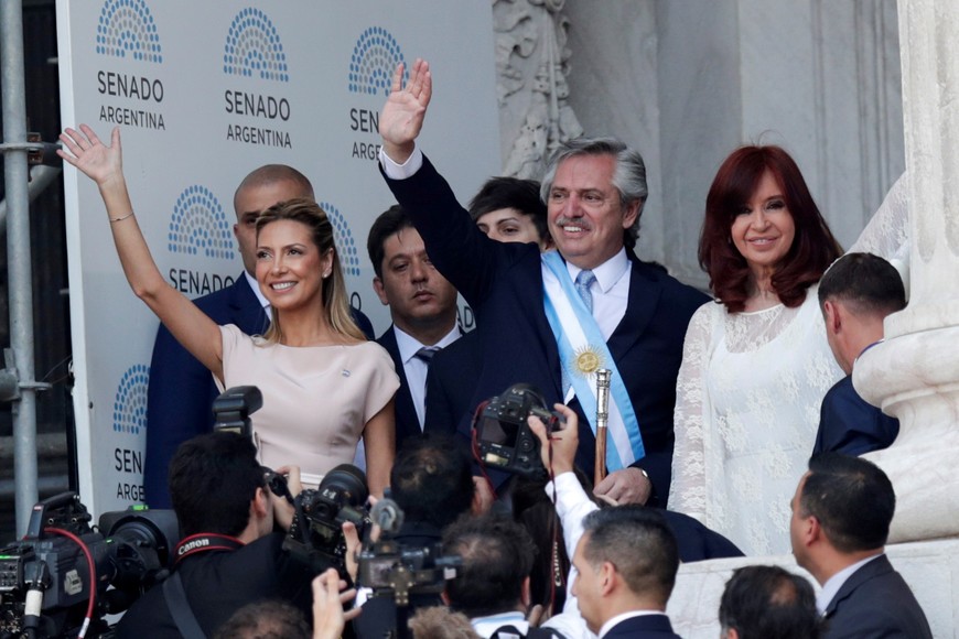 Argentina's President Alberto Fernandez waves next to his partner Fabiola Yanez and Vice President Cristina Fernandez de Kirchner after the swearing-in ceremony, in Buenos Aires, Argentina December 10, 2019. REUTERS/Ueslei Marcelino