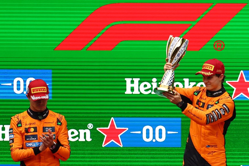 Formula One F1 - Chinese Grand Prix - Shanghai International Circuit, Shanghai, China - March 23, 2025
McLaren's Oscar Piastri celebrates with a trophy on the podium after winning the Chinese Grand Prix as second placed McLaren's Lando Norris applauds REUTERS/Edgar Su