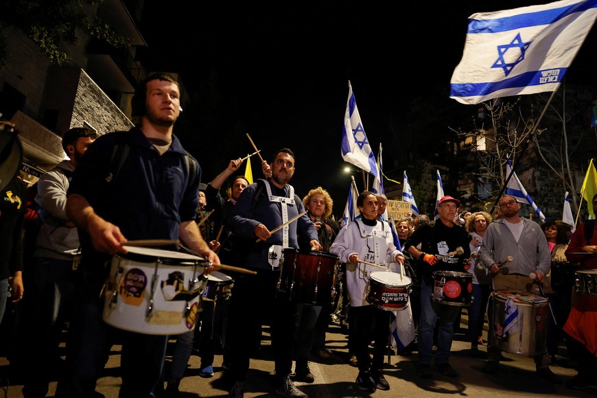 Demonstrators play drums during a protest against moves by the Israeli government to fire the Attorney General Gali Baharav Miara and the dismissal of top security agency chief, Ronen Bar, near Israeli Prime Minister Benjamin Netanyahu's residence in Jerusalem, March 24, 2025. REUTERS/Ammar Awad