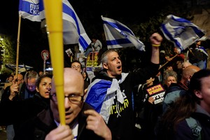 Demonstrators attend a protest against moves by the Israeli government to fire the Attorney General Gali Baharav Miara and the dismissal of top security agency chief, Ronen Bar, near Israeli Prime Minister Benjamin Netanyahu's residence in Jerusalem, March 24, 2025. REUTERS/Ammar Awad