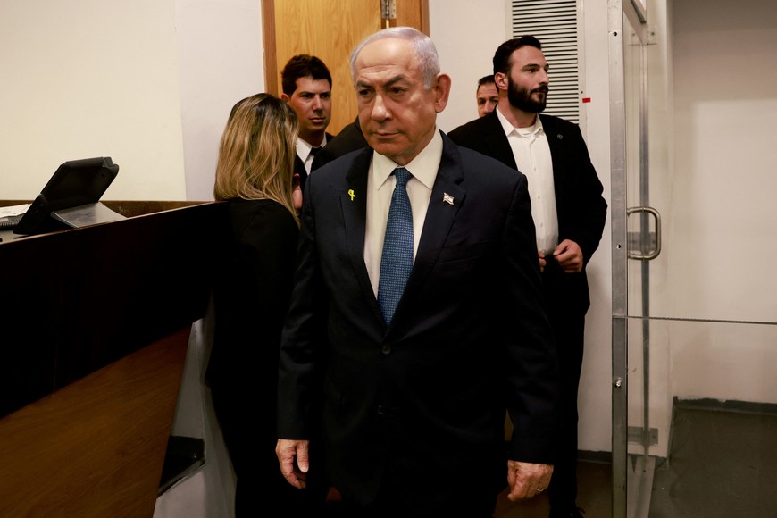 Israeli Prime Minister Benjamin Netanyahu enters the district court in Tel Aviv at the start of his hearing on corruption charges on December 10, 2024. Netanyahu, the first sitting prime minister of Israel to face a criminal trial, testified for the first time when his corruption case resumed on December 10 on charges of bribery, fraud and breach of public trust in three separate cases.     MENAHEM KAHANA/Pool via REUTERS