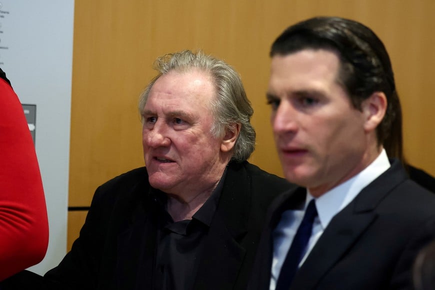 French actor Gerard Depardieu and his lawyer Jeremie Assous walk at the courthouse, as his trial over accusation of sexual assault on two women, which prosecutors say took place during the filming of "Les Volets Verts", continues in Paris, France, March 27, 2025. REUTERS/Abdul Saboor